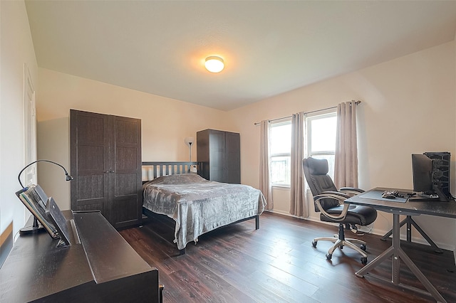 bedroom with dark hardwood / wood-style flooring