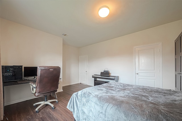 bedroom with dark wood-type flooring