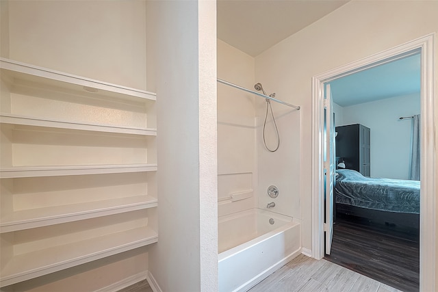 bathroom with wood-type flooring and shower / bathtub combination