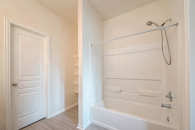 bathroom with shower / bath combination and wood-type flooring