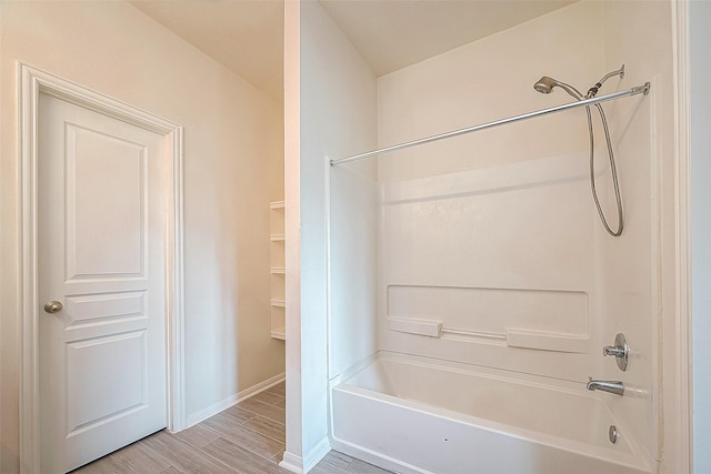 bathroom featuring hardwood / wood-style flooring and shower / bathtub combination