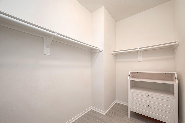 walk in closet with hardwood / wood-style floors