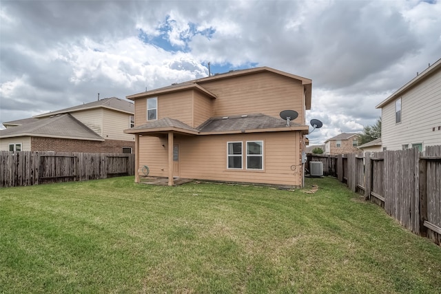 rear view of property with a yard