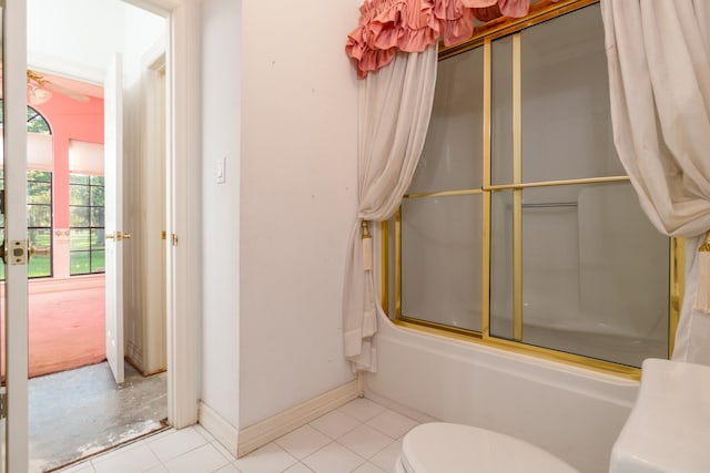 bathroom featuring toilet, tile patterned flooring, and enclosed tub / shower combo