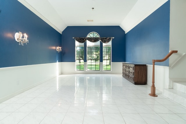 tiled spare room with vaulted ceiling and a chandelier