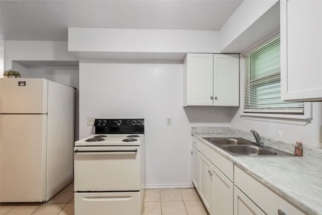 kitchen with white appliances, white cabinetry, a sink, and light tile patterned flooring