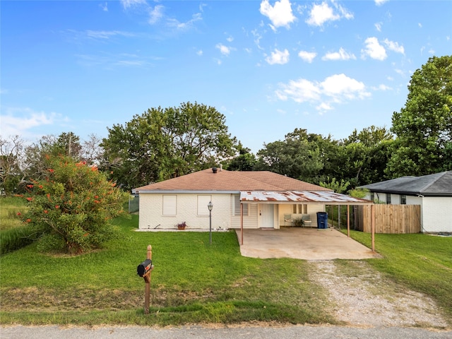 view of front of house featuring a front lawn and a patio area