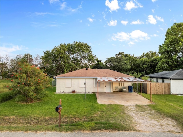 3405 Cherry Ave, Texas City, TX 77590 - view of front of home with a carport, a front yard, driveway, and fence