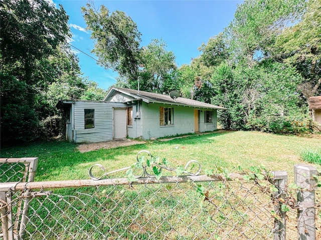 rear view of house with a lawn