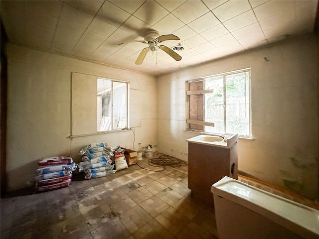 misc room with tile patterned flooring and ceiling fan