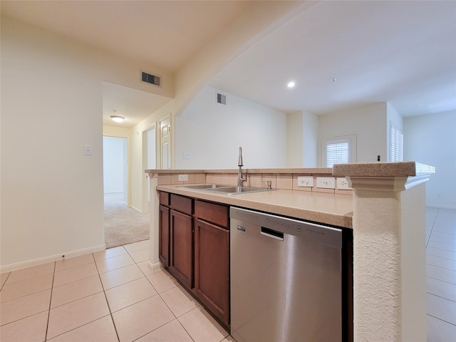 kitchen with sink, a center island with sink, dishwasher, and light tile patterned floors