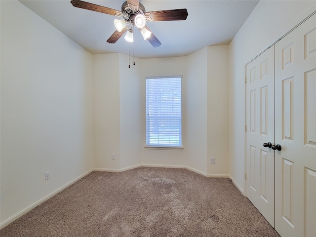 unfurnished bedroom with ceiling fan and carpet