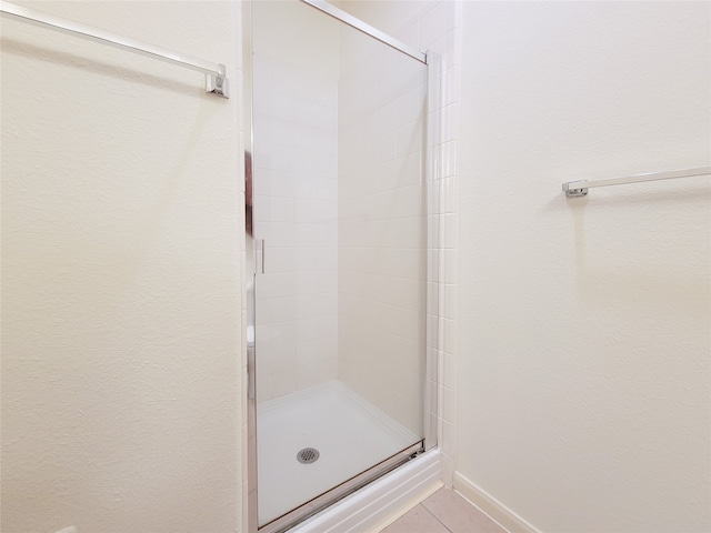 bathroom with a shower with shower door