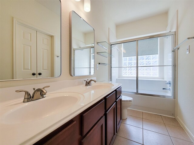 full bathroom with tile patterned flooring, enclosed tub / shower combo, double vanity, and toilet