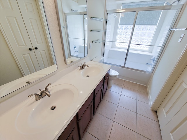 full bathroom featuring shower / bath combination with glass door, toilet, double vanity, and tile patterned floors