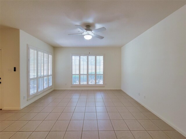 unfurnished room with ceiling fan and light tile patterned floors