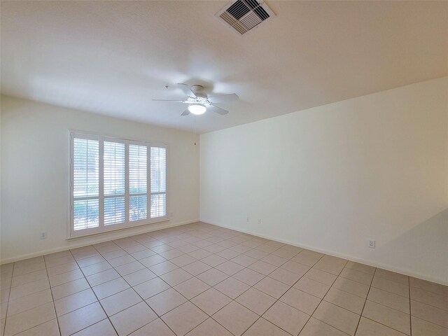 unfurnished room with ceiling fan and light tile patterned floors