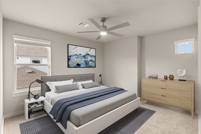 bedroom with ceiling fan and light carpet