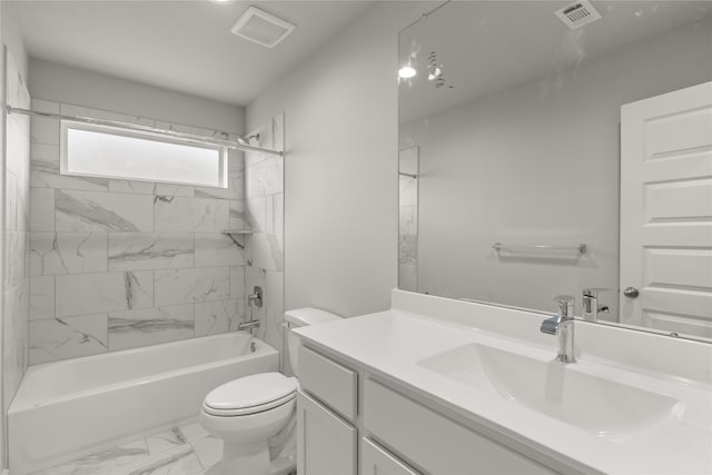 full bathroom featuring tiled shower / bath, toilet, and vanity