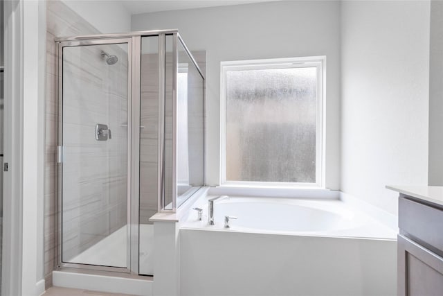 bathroom featuring independent shower and bath and vanity