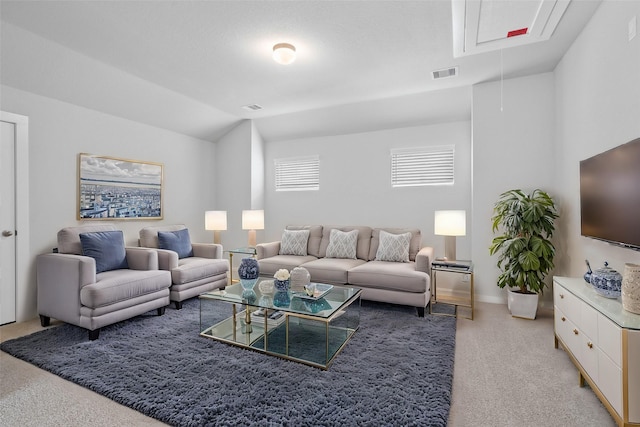 living room featuring vaulted ceiling and light colored carpet