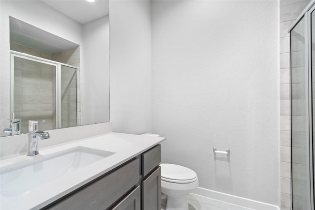 bathroom with vanity, toilet, and walk in shower