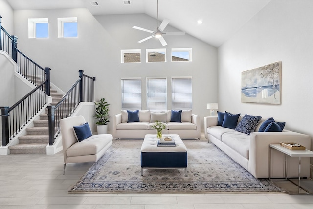 living room with high vaulted ceiling, light hardwood / wood-style flooring, and a wealth of natural light