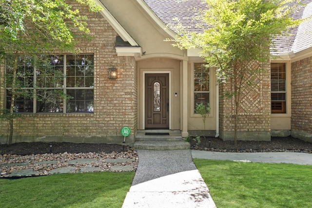 doorway to property featuring a yard