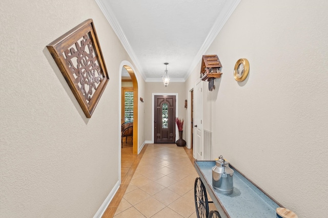 doorway featuring light tile patterned flooring and ornamental molding