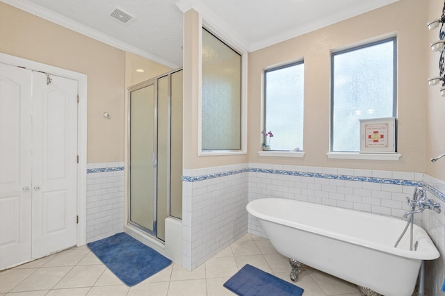 bathroom featuring plus walk in shower, tile walls, and tile patterned floors