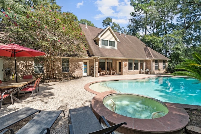 view of pool with a patio and an in ground hot tub