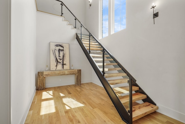 stairway with hardwood / wood-style flooring