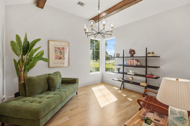 living area featuring beam ceiling, light hardwood / wood-style floors, and a notable chandelier