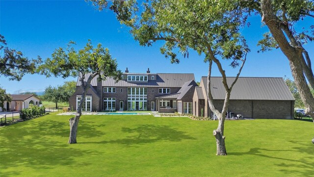 rear view of house with a pool and a patio area