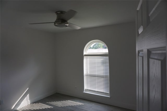 unfurnished room featuring a ceiling fan and baseboards
