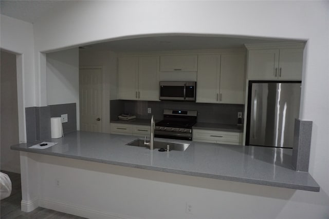 kitchen featuring sink, stainless steel appliances, and tasteful backsplash