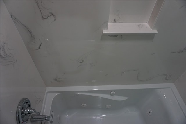 full bathroom with a tub with jets