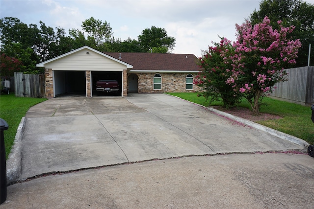 ranch-style house featuring a front lawn and a garage