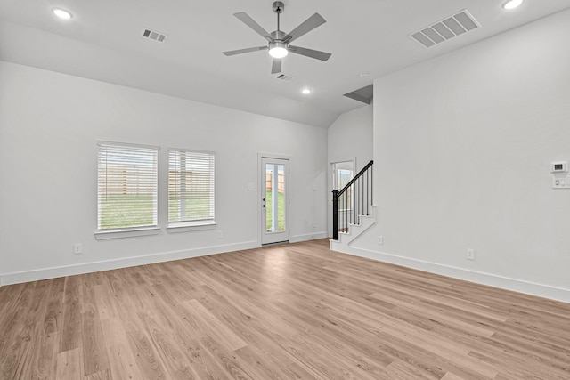 unfurnished living room featuring light wood-type flooring, stairway, baseboards, and visible vents