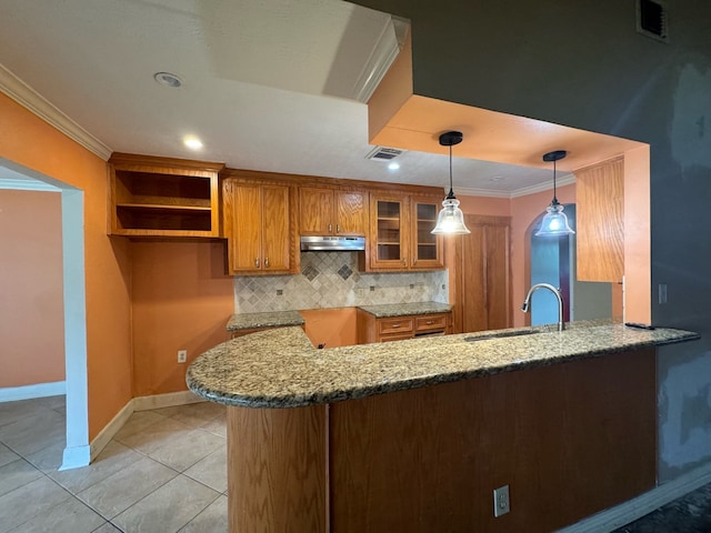 kitchen featuring decorative backsplash, sink, light stone counters, light tile patterned floors, and kitchen peninsula