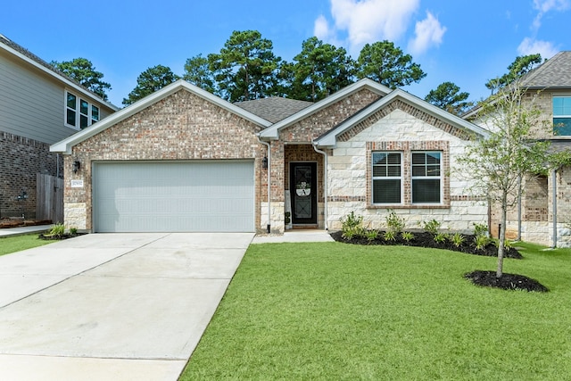 view of front of property with a garage and a front lawn