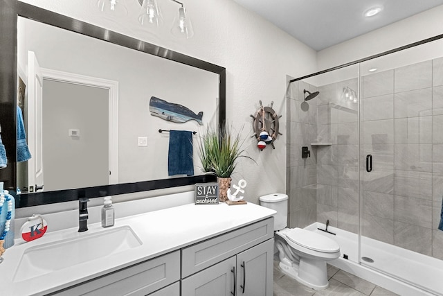 bathroom featuring toilet, vanity, walk in shower, and tile patterned floors