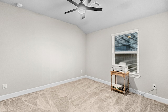 carpeted empty room featuring ceiling fan and vaulted ceiling