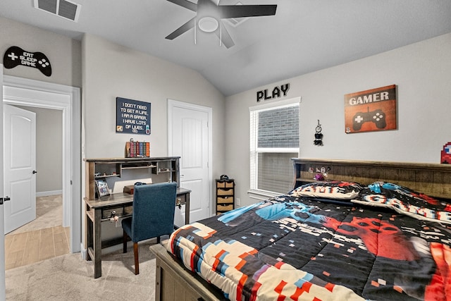 bedroom featuring ceiling fan, vaulted ceiling, and light hardwood / wood-style flooring