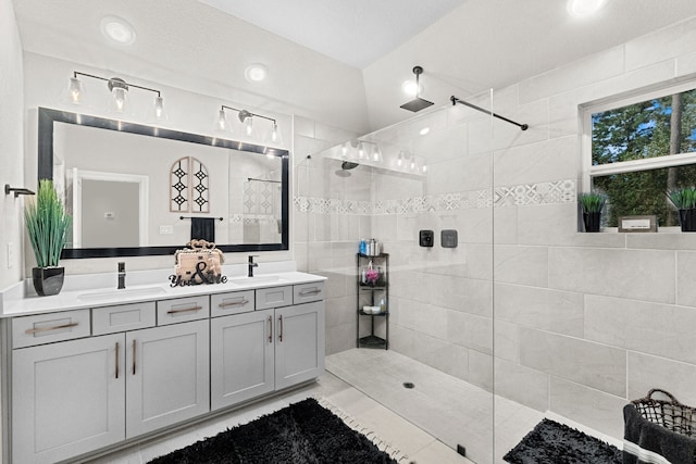 bathroom with tile patterned floors, double sink vanity, an enclosed shower, and lofted ceiling