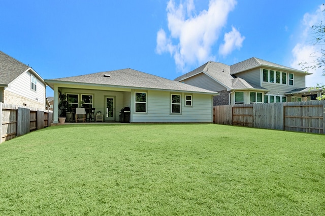 back of property featuring a yard