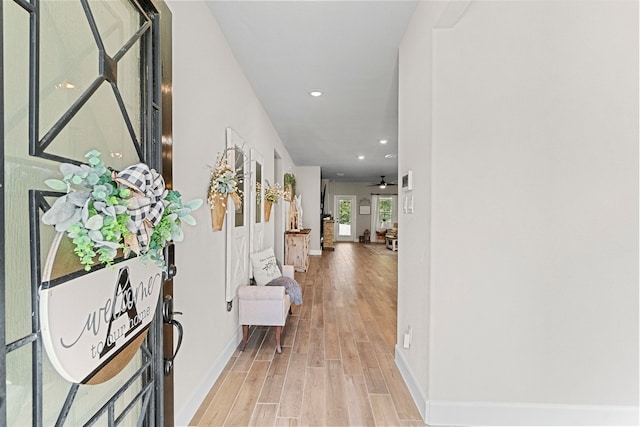 corridor with light hardwood / wood-style floors