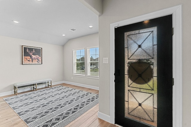 foyer with lofted ceiling and wood-type flooring