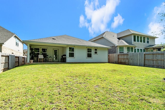 rear view of house featuring a lawn