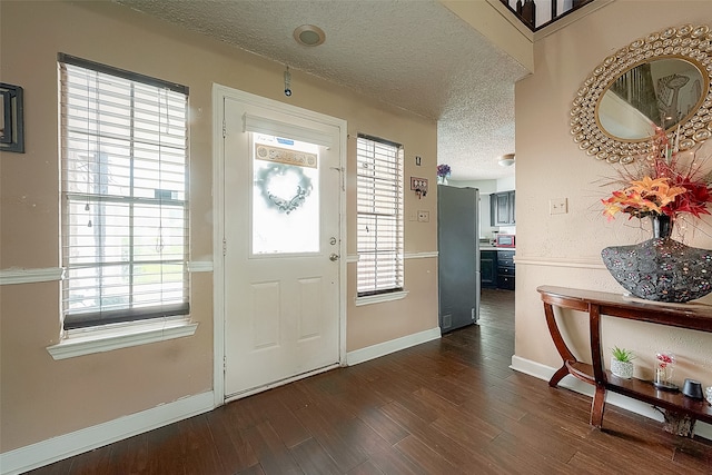 entryway featuring hardwood / wood-style floors and a textured ceiling